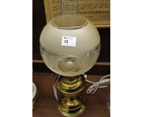 20th century brass double burner oil lamp with brass reservoir and base, etched glass shade and clear chimney. 