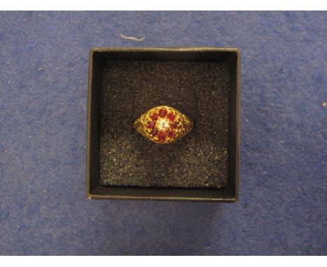 Yellow metal garnet and diamond flower head ring. 