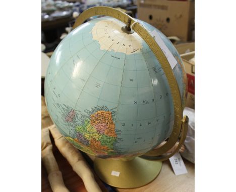 Modern revolving globe on circular gilt metal base. 