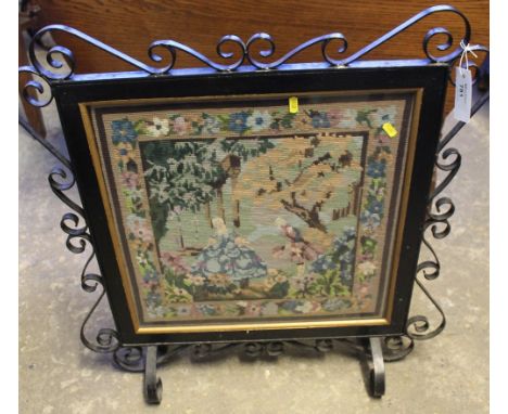 Cast metal scroll decorated tapestry inlaid fire screen.