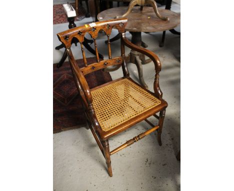 Set of three stained armchairs with open arms, cane seat on ring turned and splay legs. (3)
