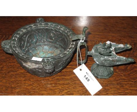 Cast metal relief decorated mortar and a cast metal double oil lamp with bird mount. (2)