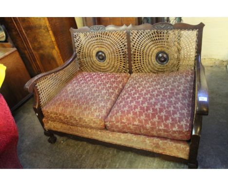 Early 20th century mahogany two seater sofa on ball and claw feet. 