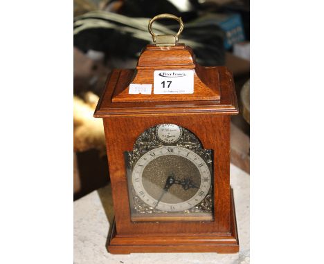 Reproduction mahogany cased Georgian style bracket clock with brass face and brass back winding movement. 