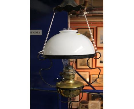 Late 19th/early 20th century brass hanging oil lamp burner with shade within scroll wrought iron frame work. 