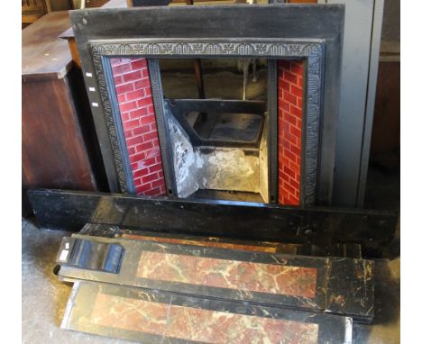 Early 20th century cast iron fireplace with tiled panels and marble surround. 