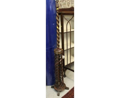 Early 20th century oak barley twist standard lamp on quatroform base. 