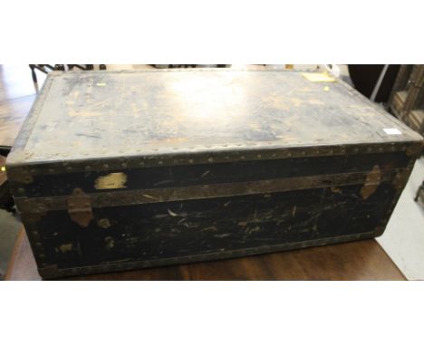 Vintage rectangular travelling trunk with metal banding and travelling paper labels. 