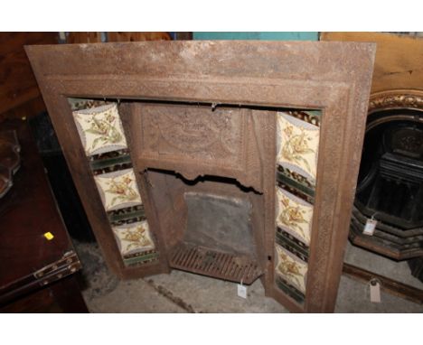 Late 19th/early 20th century cast iron fire place with floral and foliate tiled surround. 