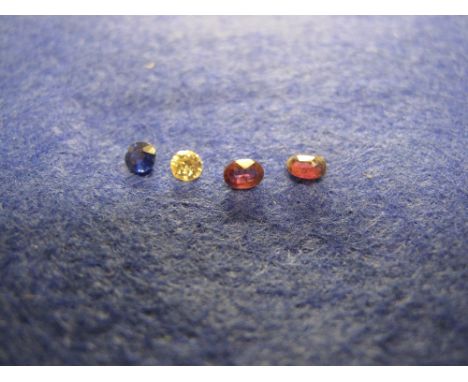 Loose stones, two garnets, one diamond and one sapphire. 