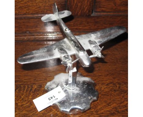 Chrome plated model of a two engine bomber on circular indented pedestal base. 