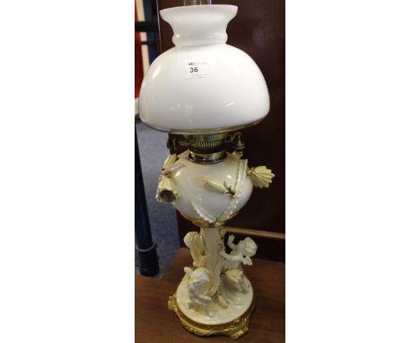 19th century Moore & Company of Worcester white glazed brass double burner oil lamp with cherub and flower head decoration on