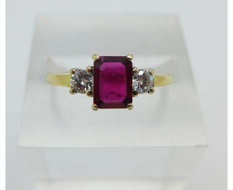 An 18ct yellow gold, ruby and diamond three stone ring, ruby weight 0.8ct, diamond weight 0.3ct, 3.7g, S