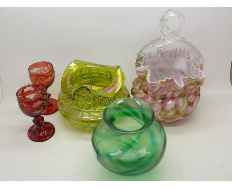 A green lustre glass vase, one other green glass vase, small chips to the rim, a glass basket and two ruby glass wines