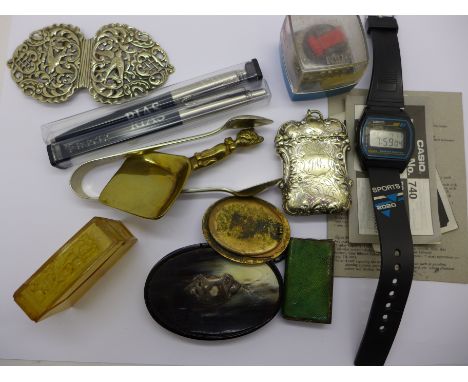 A nurse's buckle, a vesta case, a small enamel frame, (lacking back stand), a Casio digital watch, etc.