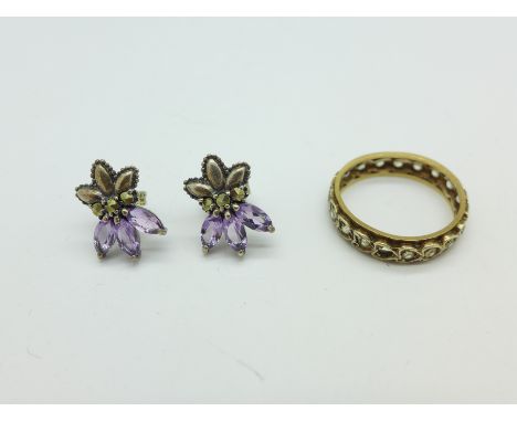 A 9ct gold and silver ring, M, lacking one stone and a pair of silver and amethyst earrings