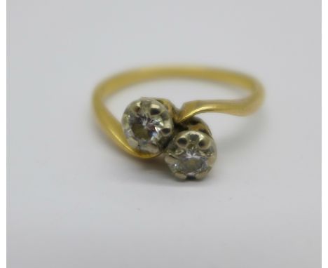 A yellow metal and two stone diamond crossover ring, 3.2g, (tests as 18ct), O