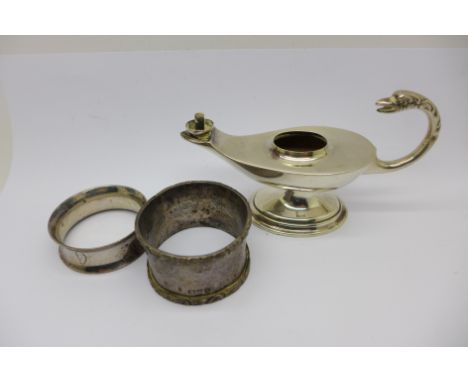 A silver 'genie' lamp table lighter, lacking top, and two silver napkin rings, 109.8g