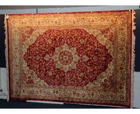 A Kashan carpet, with floral motifs on red ground, 280 x 200cm