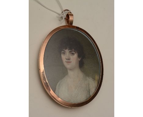 An English portrait miniature circa 1800 of a lady, wearing a white dress, reverse with locks of hair, gilt metal flowers and