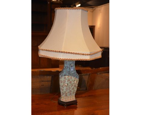 A Chinese pottery table lamp with shade, decorated with birds and Chinese symbols on green ground, 40cm high