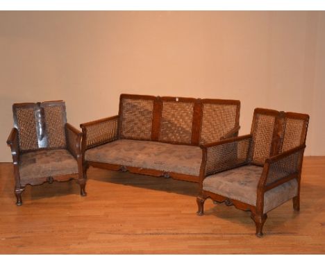 A vintage walnut three piece bergere suite, comprising of settee with pair of armchairs, raised on short cabriole supports, 7