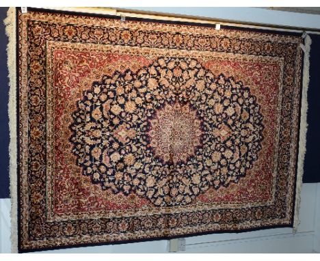 A Kashan carpet, with floral motifs on blue ground, 230 x 160cm