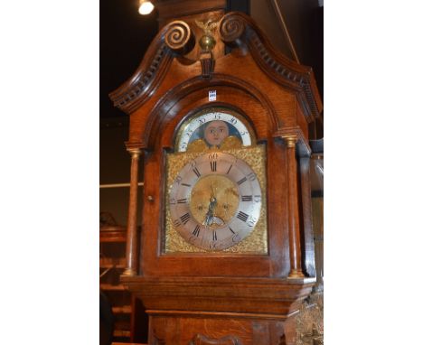 A George III oak longcase clock by John Spencer, the hood with gilt eagle and ball surmount, flanked by broken scroll pedimen