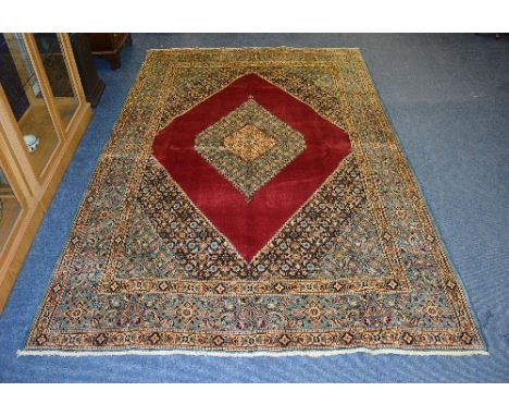 A Mood carpet, the central pale blue diamond surrounded by plain burgundy diamond over pale blue ground, with gold decoration
