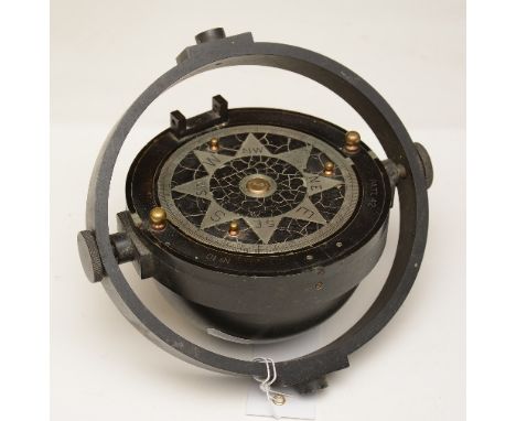 An early to mid 20th century vintage metal compass, raised on gimble support, 10cm high x 18cm wide