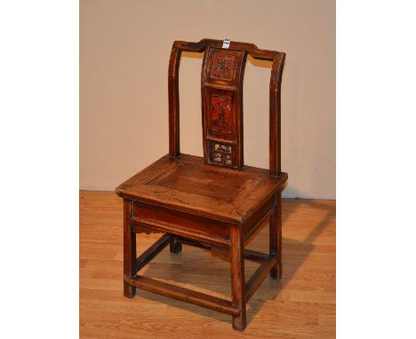 A late 19th/early 20th century Chinese hardwood low chair, with three carved floral and figural panels, solid seat, with unde