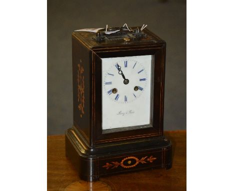 A 19th century mantel clock by Leroy of Paris, with sliding glass enclosing white enamel dial with Roman numerals, striking b