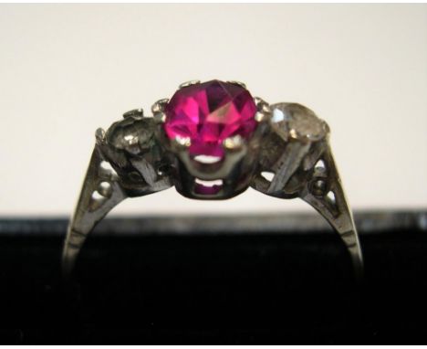 9ct yellow gold ring with a central ruby, flanked by 2 clear stonesApprox 1.8 grams gross,          size Q 