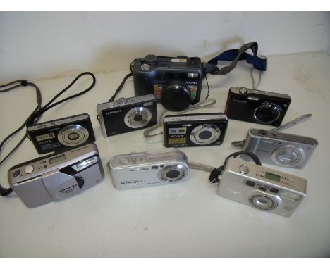 Box of various compact digital cameras and a Minolta Vectis 300L compact film camera, cine camera etc 