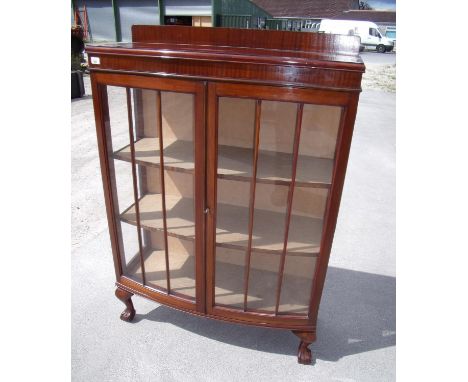 Early - mid 20th C mahogany bow front display cabinet enclosed by two glazed doors, on ball and claw feet (width 90cm) 