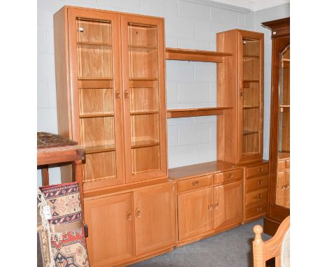 An ercol light elm wall unit, 231cm by 44cm by 214cmThe full unit is illustrated, and seperates into three base units, two ca