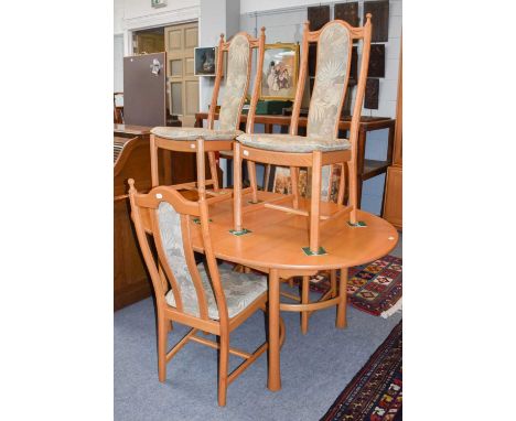 An Ercol light elm extending dining table, 160cm (closed) by 107cm by 73cm, and four matching chairs