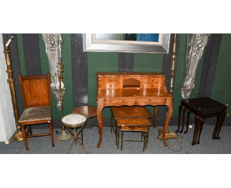 A reproduction light walnut desk, crossbanded and strung, with raised four drawer superstructure and scroll supports, 155cm b