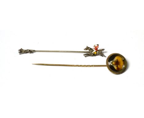 A pin with diamond set running fox at one end and diamond and enamelled mounted huntsman at the other end, length 7.4cm and a