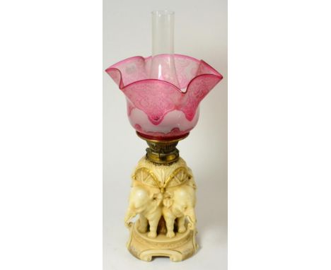 An Austrian porcelain oil lamp base, circa 1900, in Royal Worcester style, modelled by as four elephants about a central stem