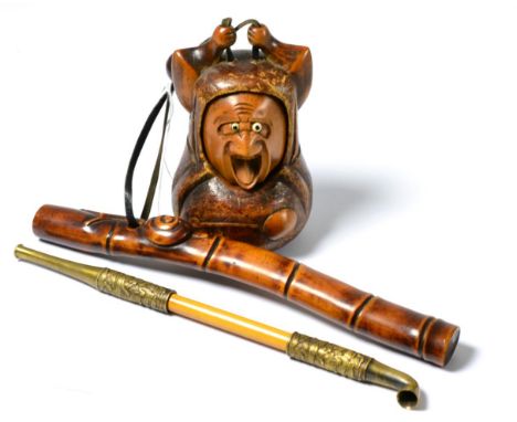 A Japanese carved wood tobacco box, pipe and holder 