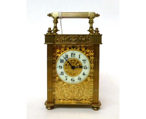 * A brass carriage timepiece, circa 1900, carrying handle, glazed pierced side panels, enamel Arabic numeral chapter ring sur
