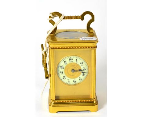 A brass striking carriage clock, circa 1900, carrying handle, enamel Arabic chapter ring, twin barrel movement with a silvere