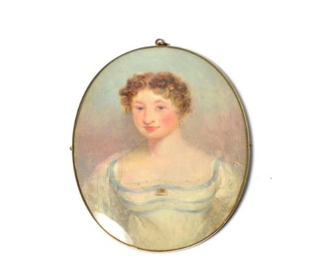 An early 19th century oval portrait miniature on Ivory, depicting a young woman, half length, wearing a white silk dress with