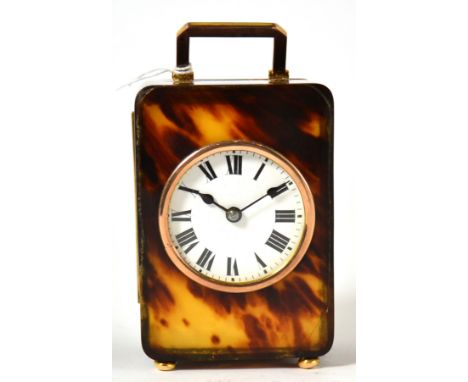 A tortoiseshell and 9ct gold mounted timepiece, 1919, 9ct gold carrying handle, gold mounts with London hallmarks, bun shaped