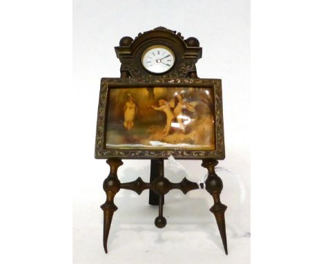 * A picture easel form timepiece, early 20th century, central framed picture scene depicting winged cherubs next to a river, 
