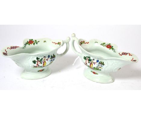 A pair of early first period Worcester porcelain sauceboats, circa 1754, of shaped oval form, painted in colours with figures