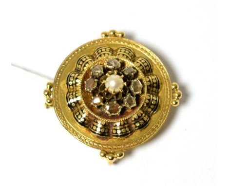 A Victorian enamel, diamond and pearl set brooch, measures 4cm in diameter The brooch is in good condition. It fastens with a