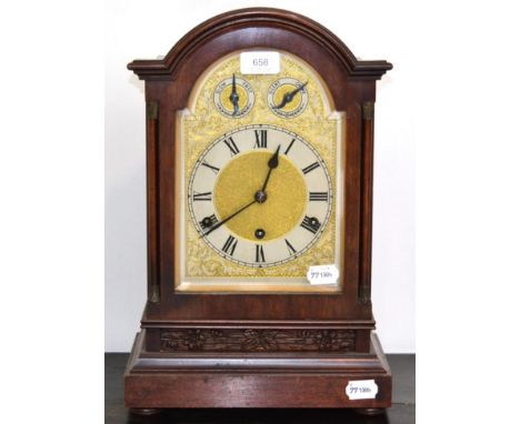 A mahogany chiming table clock, circa 1910, arched case, side sound frets, silvered Roman chapter ring, two dials in the arch