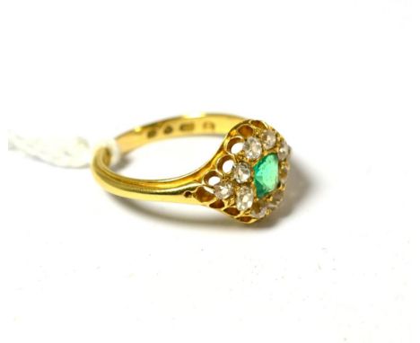 An 18ct gold emerald and diamond cluster ring, the square step cut emerald within a border of old cut diamonds, total estimat